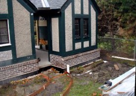 Rear garage downspout will connect to system and to existing french drain shown along fence at right.