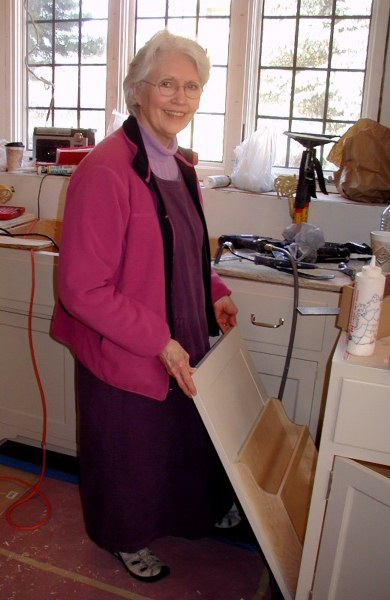 Carol demonstrating special vertical storage cabinet
