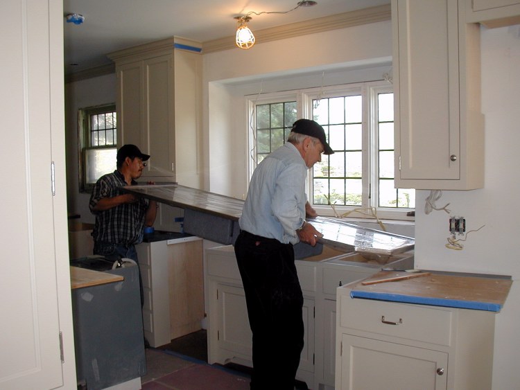 Sabastion helps Larry mount sink and drain board
