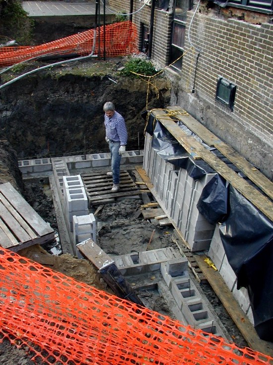 Jack Lezotte surveys poured footers and first row of block.