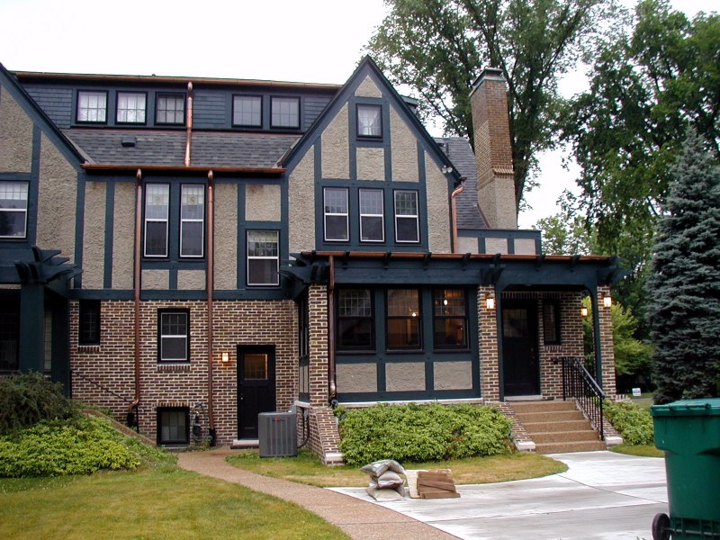 Porch railing includes fleur-de-lis motif in wrought iron.