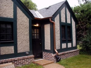 Rear of garage also gets a makeover: new door, entrance light, stoop, and walkway.