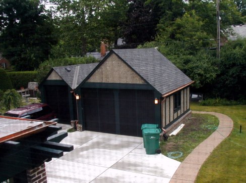 Lights add finishing touch to new garage face. Screen window casts pattern on driveway.