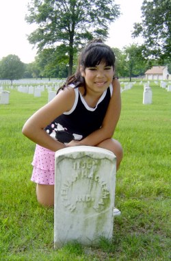 Mary kneels at the grave of Hezekiah Hackleman