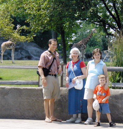 Three generations enjoy the fresh air and the animals together