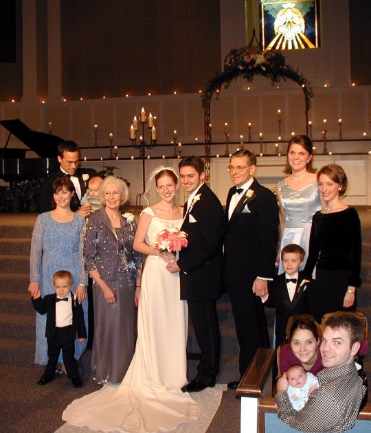 Sarah with Tom's family. Laura, Kenton and baby Tyler peek in.